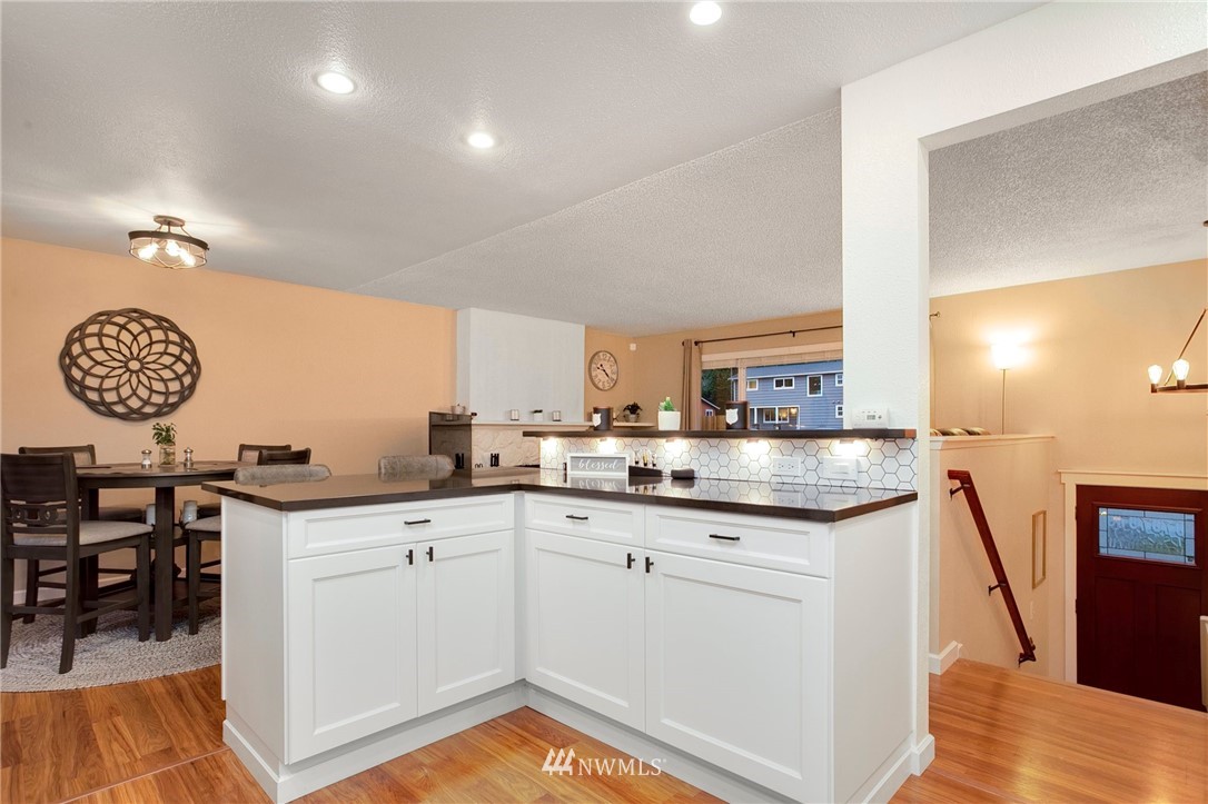10727 126th Avenue Northeast Kirkland, WA 98033 - Photo 7 of 40 a kitchen with granite countertop a sink and cabinets