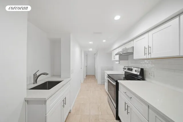 a kitchen with stainless steel appliances granite countertop a sink and cabinets
