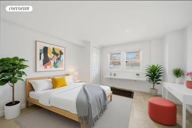 a bedroom with a large bed and a potted plant