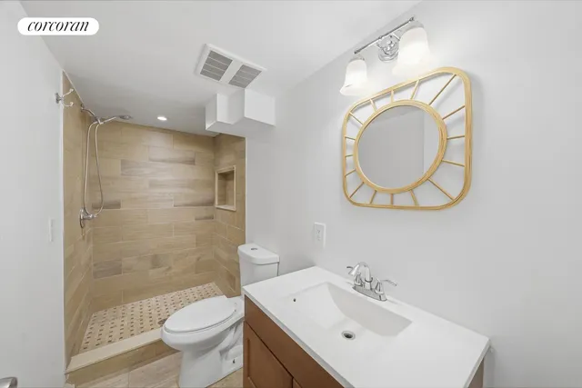 a bathroom with a sink mirror toilet and shower