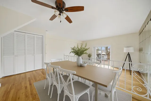 a balcony with wooden floor table and chairs