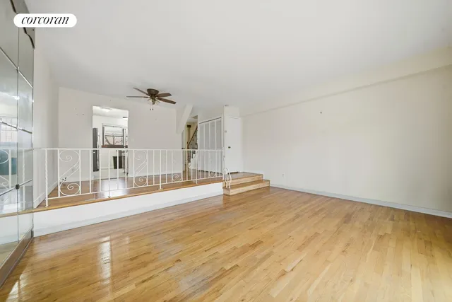 a view of a room with wooden floor