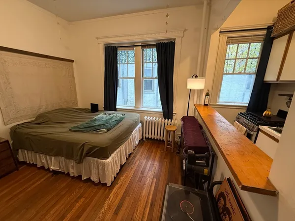 a spacious bedroom with a bed and a large window