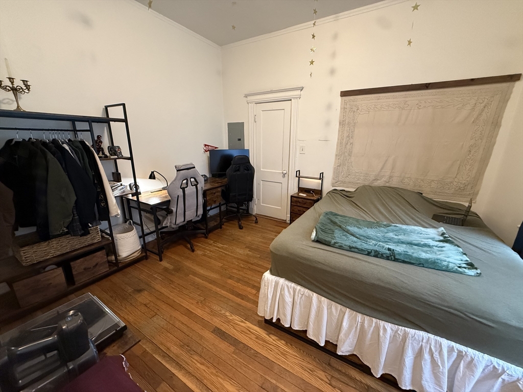 1111 Boylston Street, Unit 25 Boston, MA 02215 - Photo 3 of 9 a bedroom with wooden floor and furniture