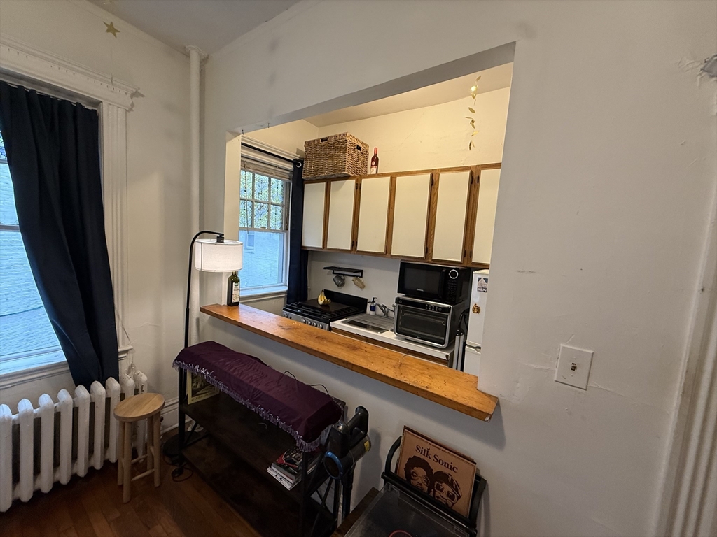 1111 Boylston Street, Unit 25 Boston, MA 02215 - Photo 4 of 9 a room with furniture and flat screen tv