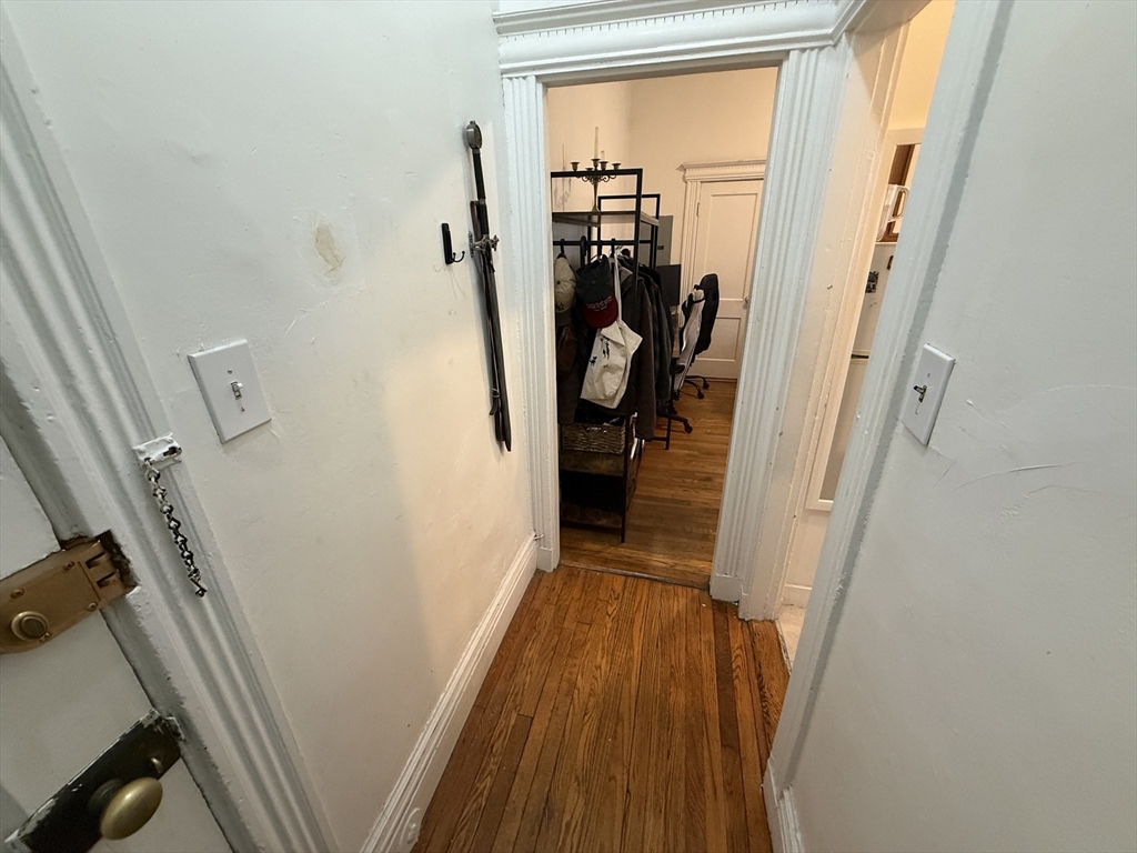 1111 Boylston Street, Unit 25 Boston, MA 02215 - Photo 6 of 9 a view of a hallway with wooden floor and stairs