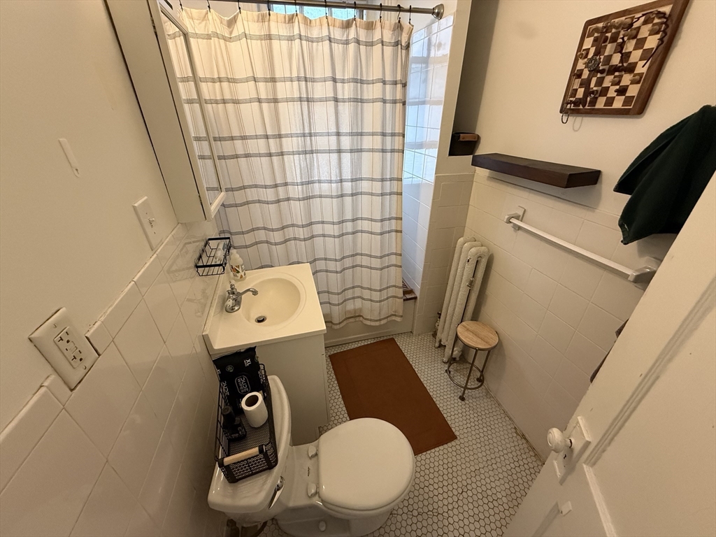 1111 Boylston Street, Unit 25 Boston, MA 02215 - Photo 8 of 9 a bathroom with a sink toilet and shower