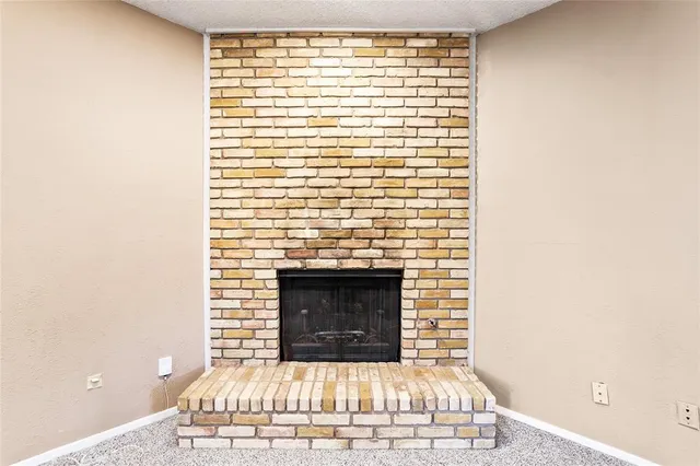 a view of a livingroom with a chandelier fan and a kitchen