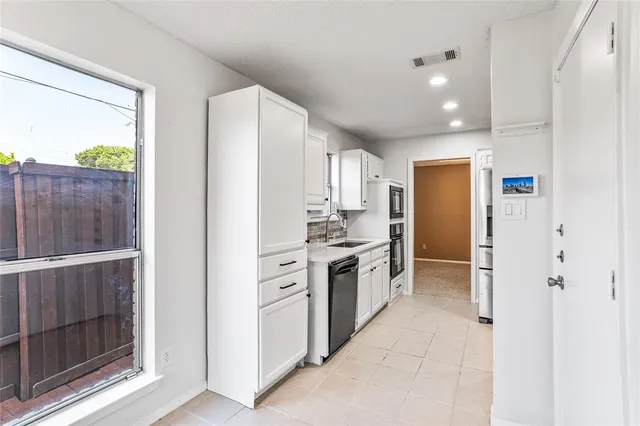 an empty room with windows and city view