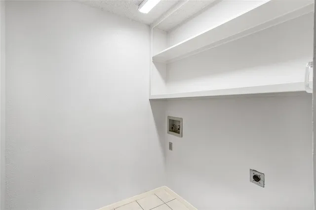 an empty room with a ceiling fan and window