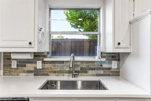 a kitchen with a sink and a window