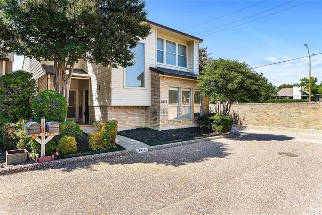 a front view of a house with a yard and a garage