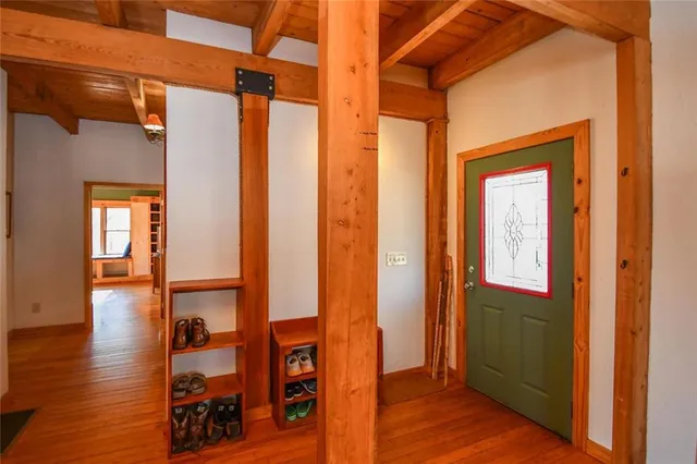 a view of a dining room with furniture a chandelier and wooden floor