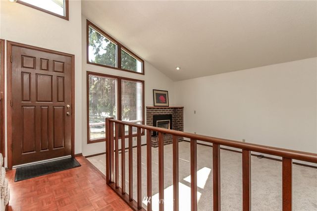 a view of a hallway with wooden floor and entryway