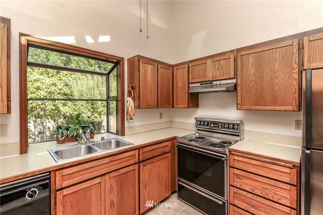 a kitchen with granite countertop a stove and a sink