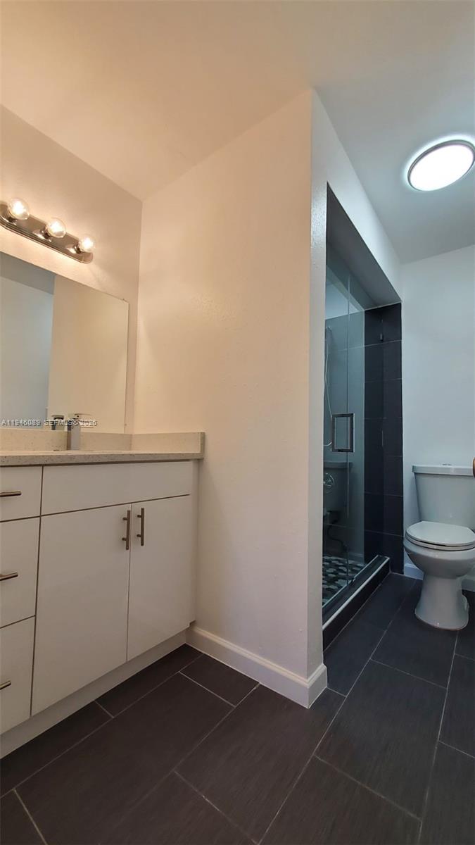 10500 Southwest 155th Court, Unit 1022 Miami, FL 33196 - Photo 15 of 41 a bathroom with a sink a toilet and a mirror