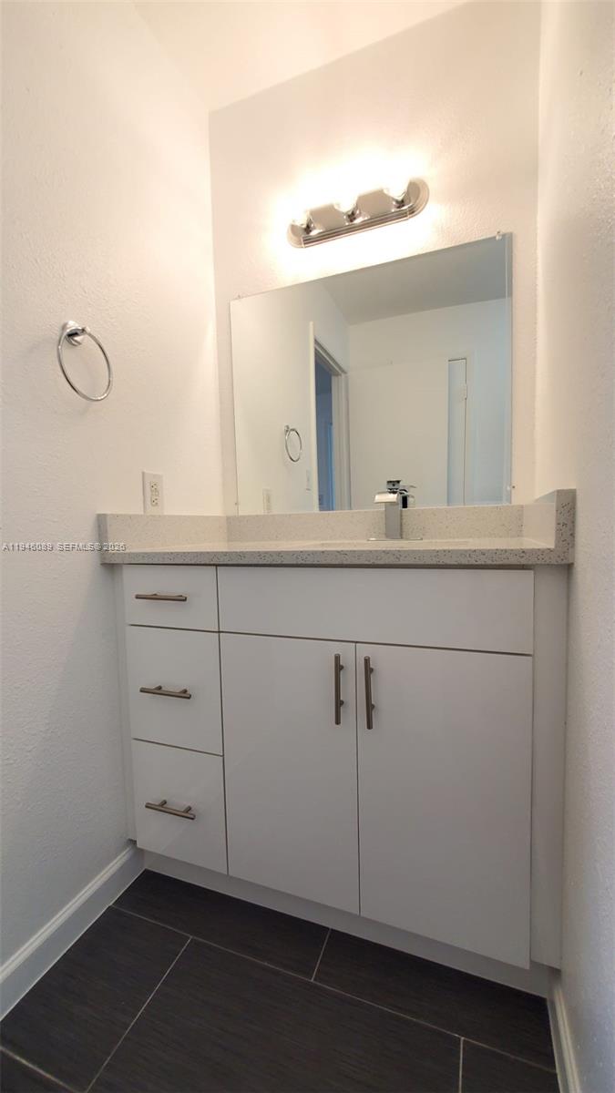 10500 Southwest 155th Court, Unit 1022 Miami, FL 33196 - Photo 16 of 41 a bathroom with a sink and mirror