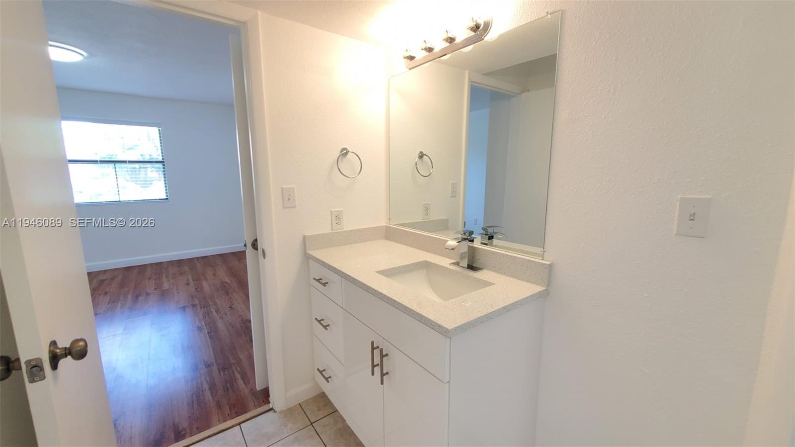 10500 Southwest 155th Court, Unit 1022 Miami, FL 33196 - Photo 24 of 41 a bathroom with a sink vanity granite and a mirror