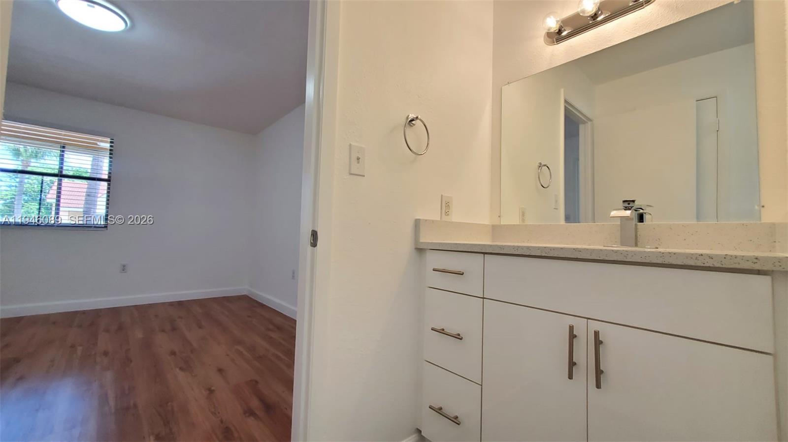 10500 Southwest 155th Court, Unit 1022 Miami, FL 33196 - Photo 25 of 41 a bathroom with a sink and a mirror