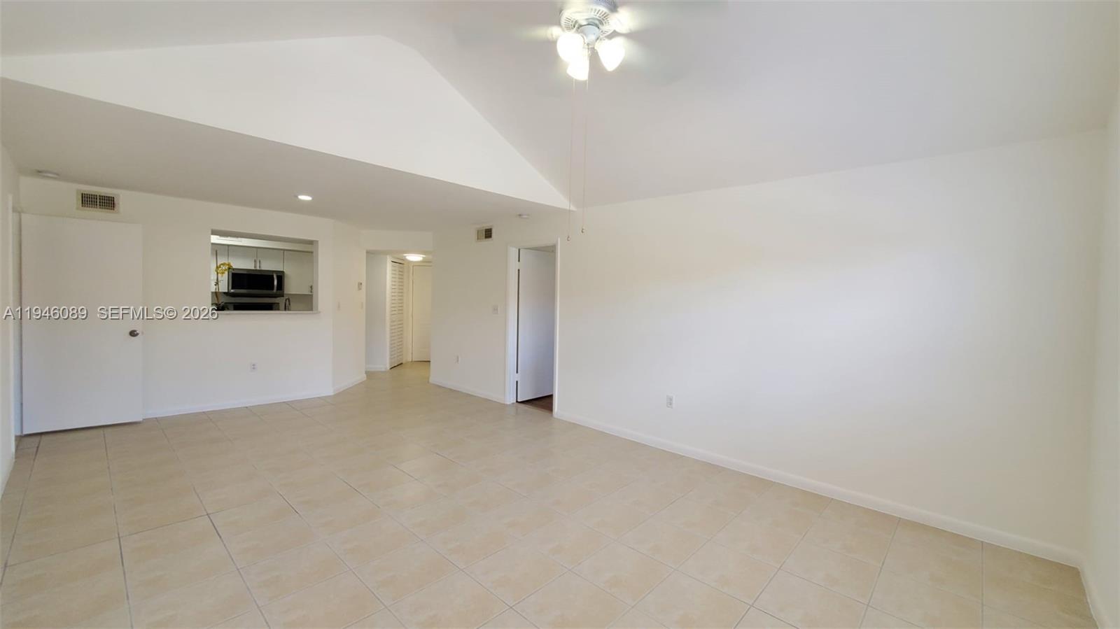 10500 Southwest 155th Court, Unit 1022 Miami, FL 33196 - Photo 30 of 41 a view of an empty room with a chandelier