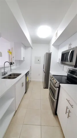 a kitchen with a sink appliances and cabinets