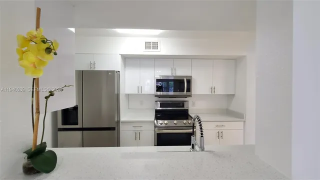 a kitchen with stainless steel appliances a refrigerator sink and stove