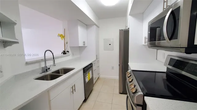 a kitchen with stainless steel appliances a sink and a stove