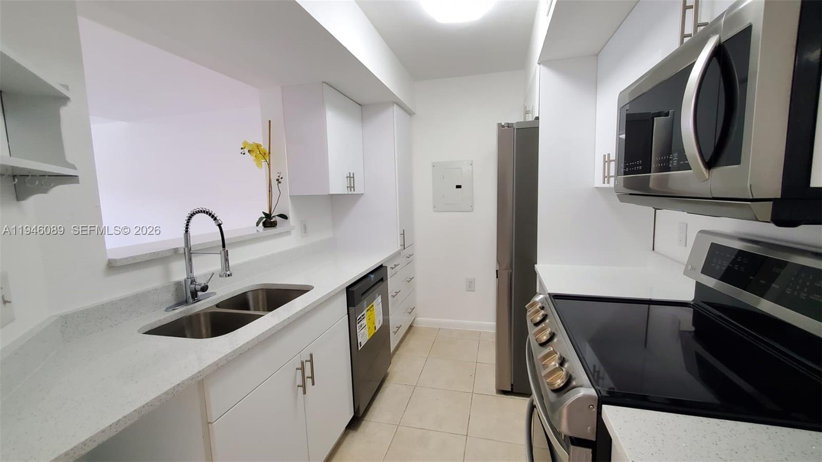 10500 Southwest 155th Court, Unit 1022 Miami, FL 33196 - Photo 9 of 41 a kitchen with stainless steel appliances a sink and a stove