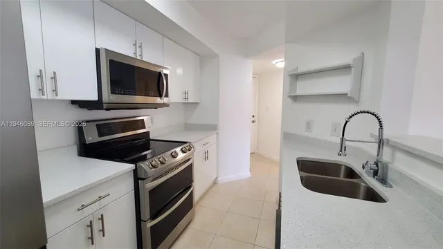 a kitchen with a microwave and a sink