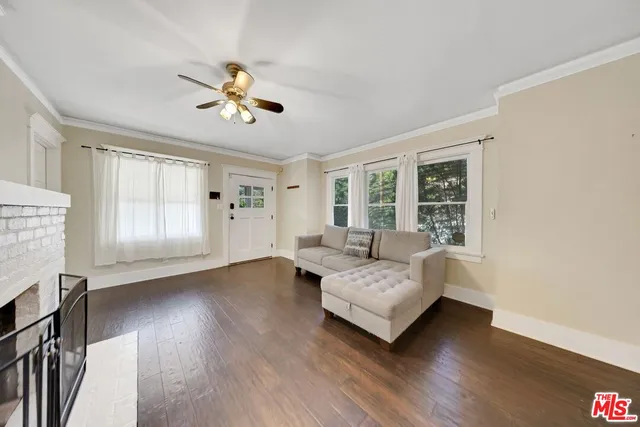a living room with furniture fireplace and flat screen tv