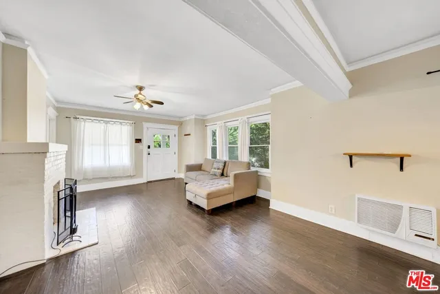 a dining room with furniture wooden floor a rug and a painting