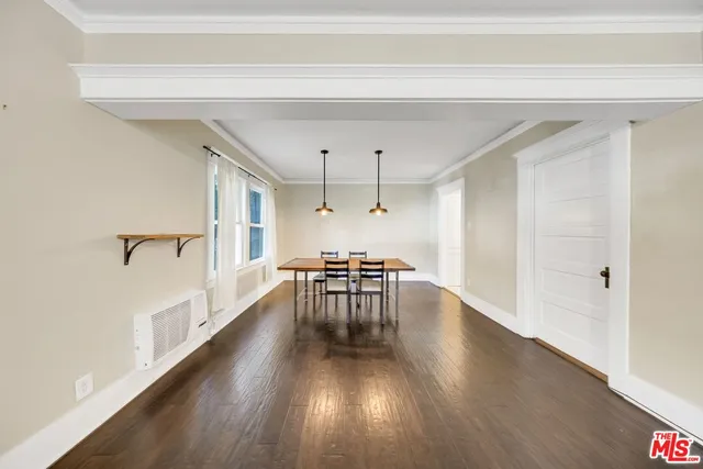 a view of a room with furniture and wooden floor