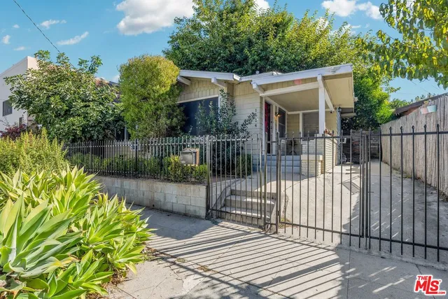 a view of a house with wooden fence