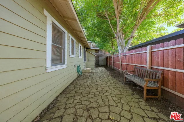 a view of a backyard with a small cabin and a chair