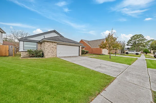 a front view of a house with a garden and yard