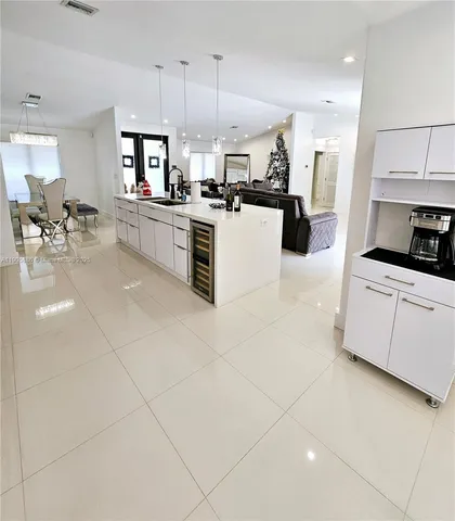 a kitchen with stainless steel appliances kitchen island granite countertop a stove a sink a microwave and a refrigerator