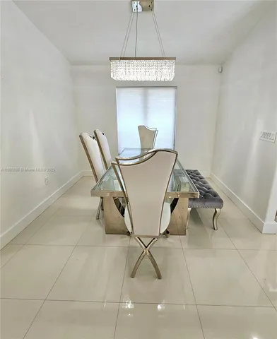 a living room with a table and chairs