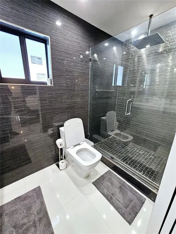 a bathroom with a sink a toilet and mirror