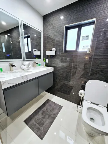 a spacious bedroom with a bed and a potted plant