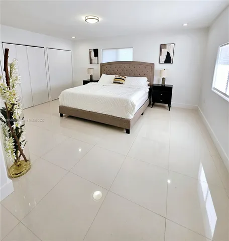 a bedroom with a bed and cabinets