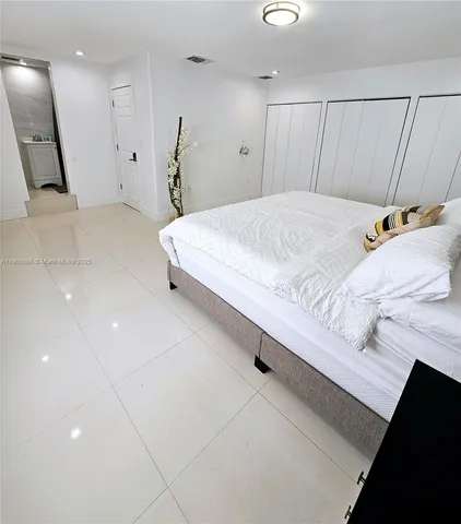 a bedroom with a bed and a walk in closet