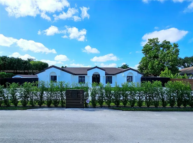 a front view of a house with a garden