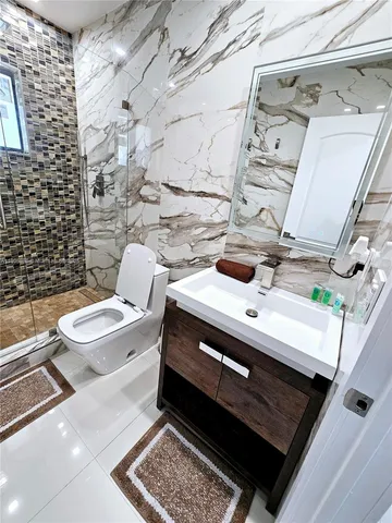 a bathroom with a sink a toilet and shower curtain