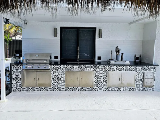 a backyard of a house with potted plants and wooden fence