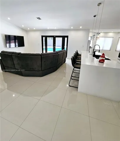 a view of a living room a couch and a chandelier