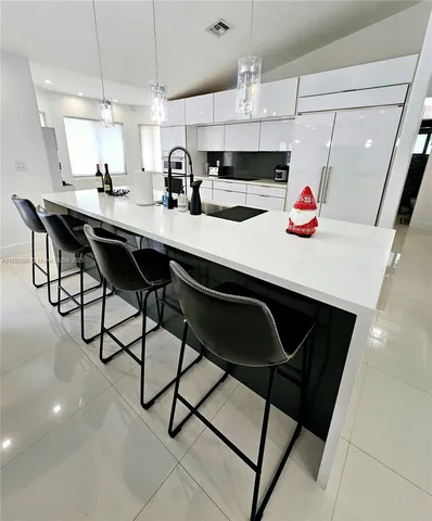 a kitchen with stainless steel appliances kitchen island granite countertop a sink and cabinets