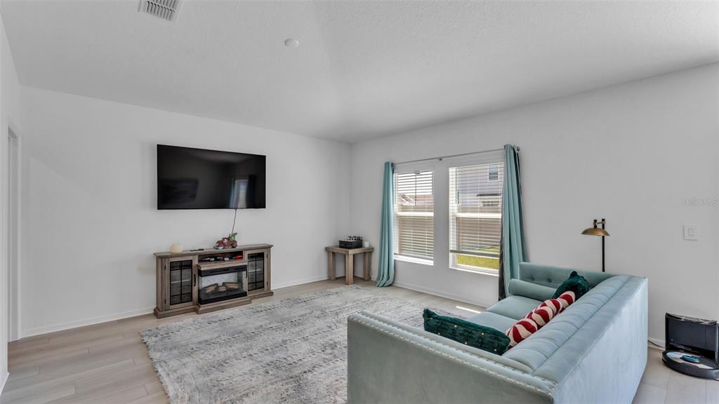 1624 Marksman Road Eagle Lake, FL 33839 - Photo 12 of 42 a living room with furniture and a flat screen tv