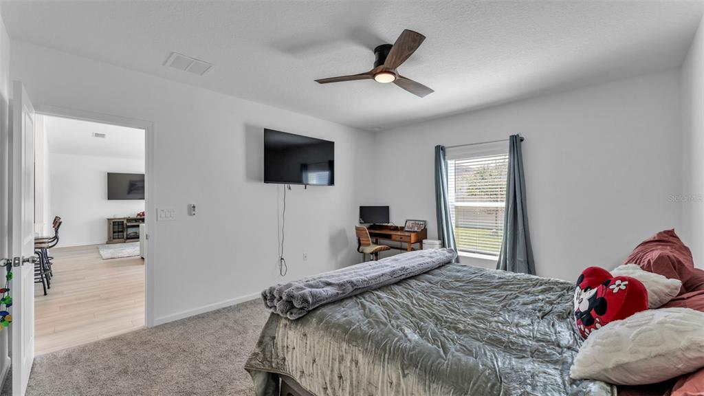 1624 Marksman Road Eagle Lake, FL 33839 - Photo 17 of 42 a bedroom with a bed and a flat screen tv