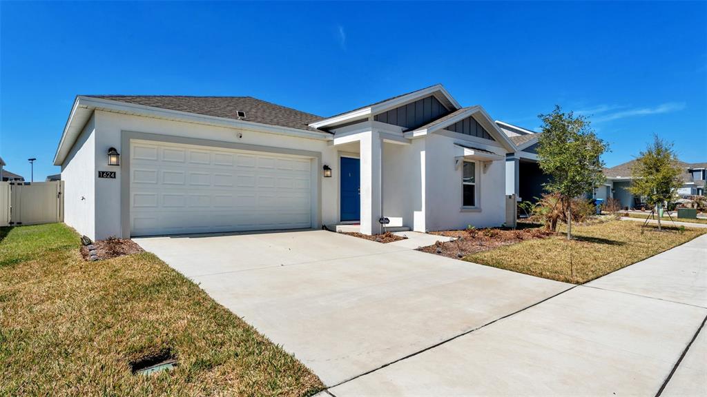 1624 Marksman Road Eagle Lake, FL 33839 - Photo 2 of 42 a front view of a house with a garage