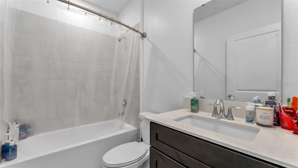 1624 Marksman Road Eagle Lake, FL 33839 - Photo 24 of 42 a bathroom with a granite countertop sink toilet and shower